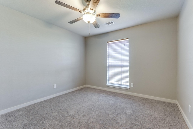 spare room with ceiling fan, plenty of natural light, and carpet flooring