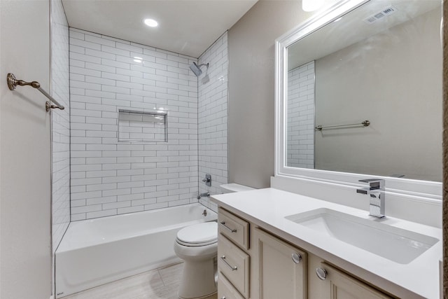 full bathroom featuring toilet, vanity, and tiled shower / bath combo