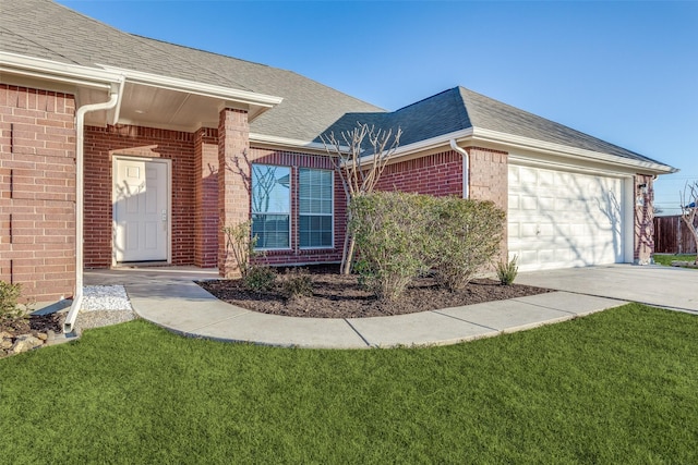 property entrance with a garage and a lawn