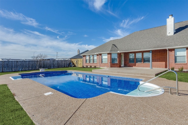 view of pool featuring a diving board and a patio area