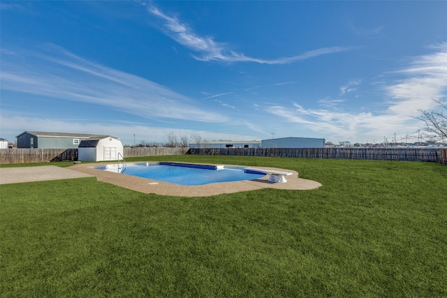 view of pool with a diving board, a yard, and a storage unit