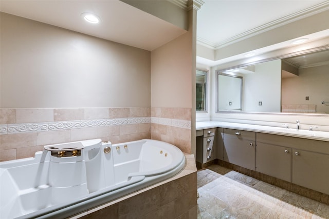 bathroom with tiled bath, vanity, and ornamental molding