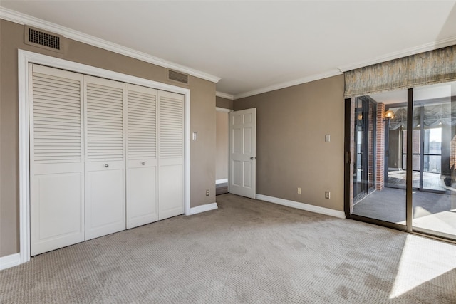 unfurnished bedroom with carpet floors, access to exterior, a closet, and ornamental molding