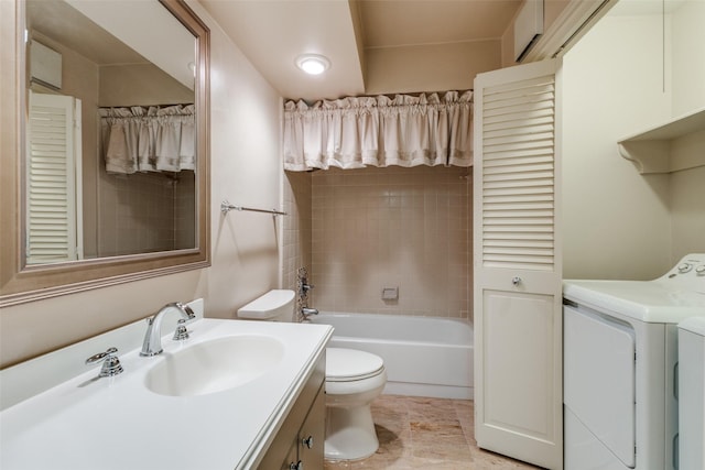 bathroom featuring toilet, vanity, and washing machine and clothes dryer