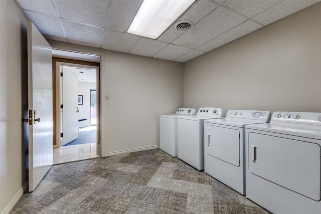 clothes washing area with washing machine and dryer and carpet flooring