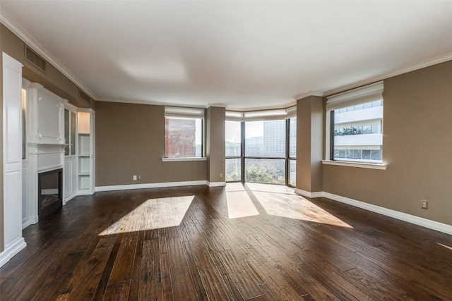 unfurnished living room featuring dark hardwood / wood-style floors and crown molding