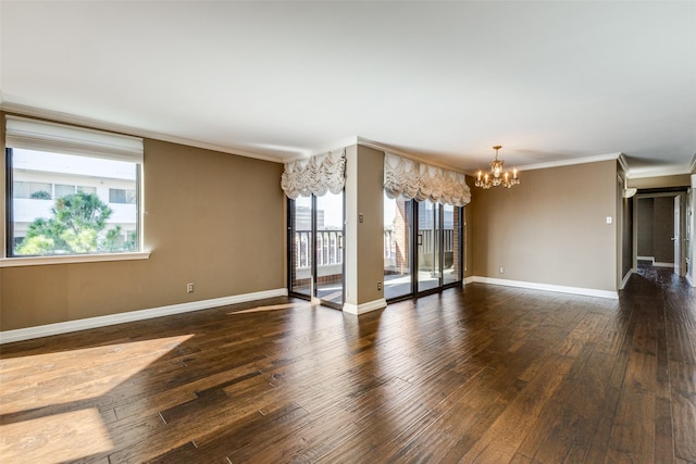 empty room with an inviting chandelier, crown molding, and dark hardwood / wood-style floors