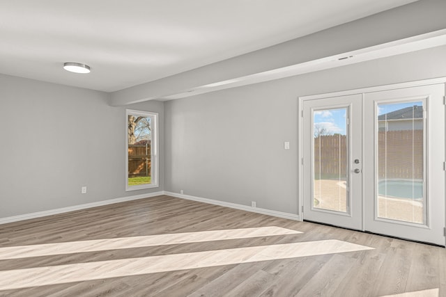 empty room featuring light hardwood / wood-style flooring and french doors