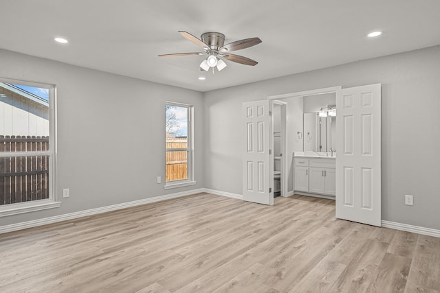 unfurnished bedroom featuring ceiling fan, light hardwood / wood-style floors, and ensuite bath