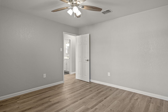 unfurnished room featuring light wood-type flooring and ceiling fan