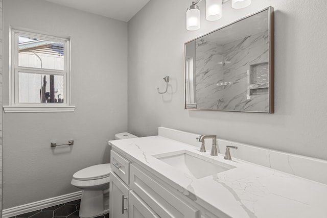 bathroom featuring toilet, tile patterned floors, and vanity