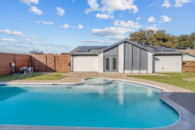 view of pool with an in ground hot tub and a lawn