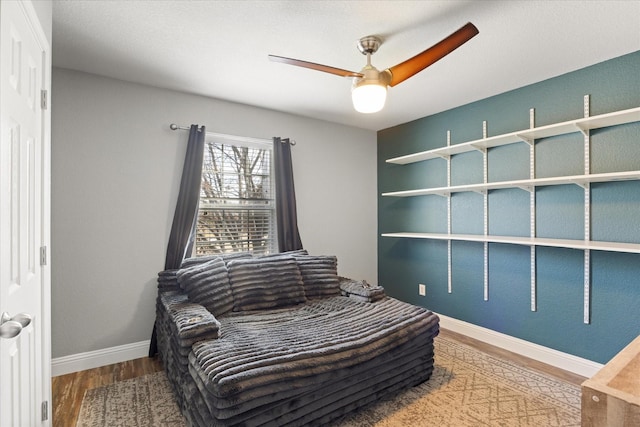 bedroom with ceiling fan and wood-type flooring