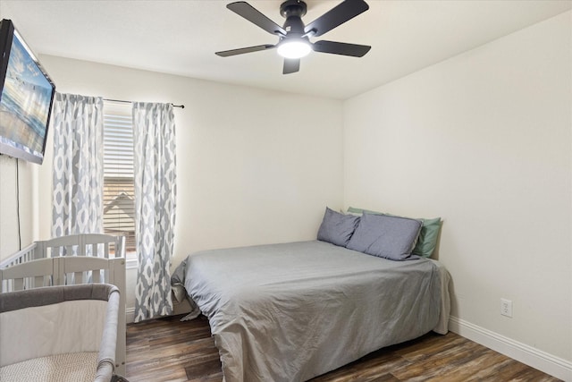 bedroom with ceiling fan and dark hardwood / wood-style flooring