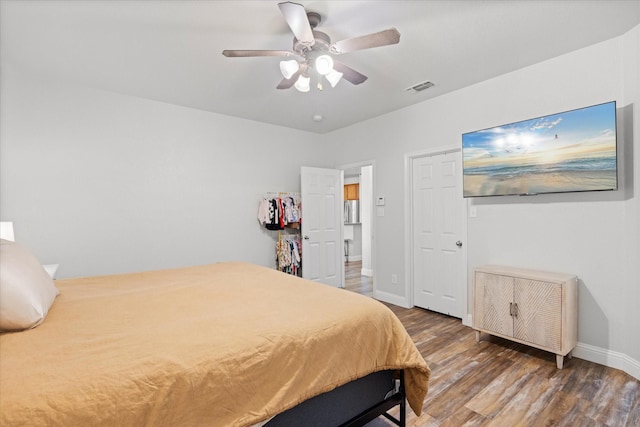 bedroom with ceiling fan and dark hardwood / wood-style floors