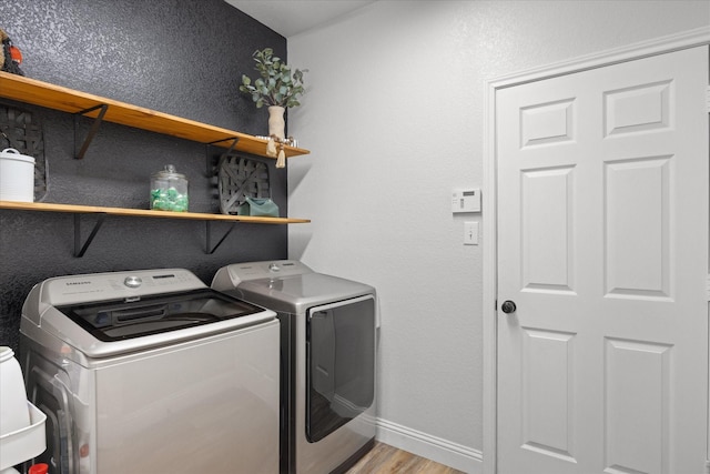 laundry room featuring light wood-type flooring and washer and dryer