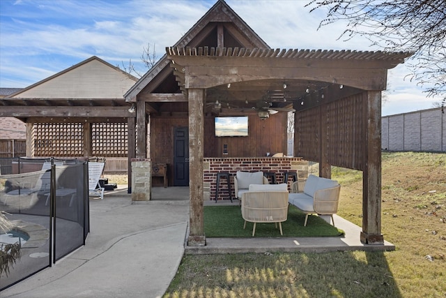 view of patio / terrace with ceiling fan and a pergola