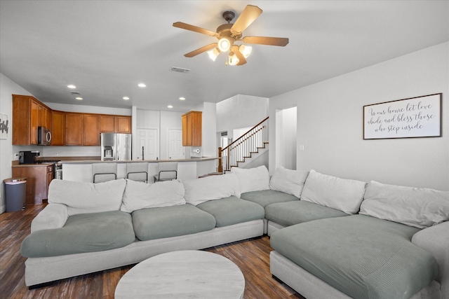 living room with ceiling fan and dark hardwood / wood-style floors