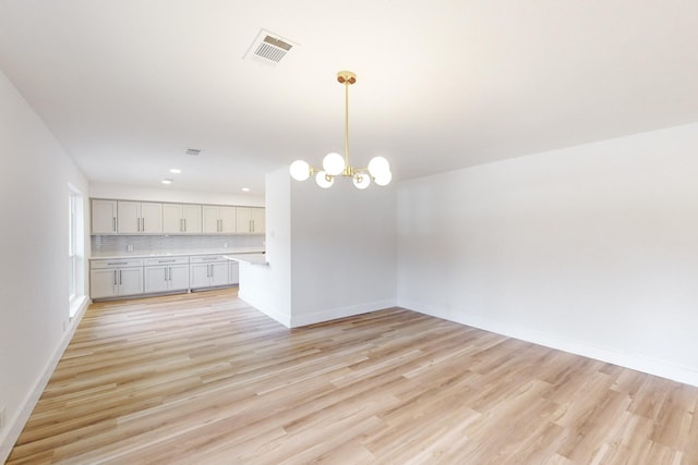 interior space featuring a chandelier and light hardwood / wood-style floors