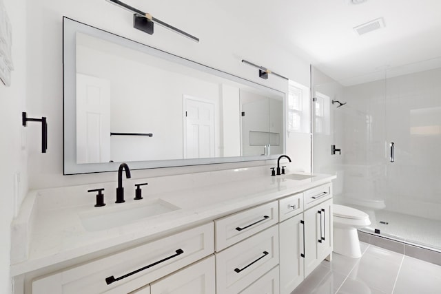 bathroom with toilet, vanity, tile patterned flooring, and a shower with door