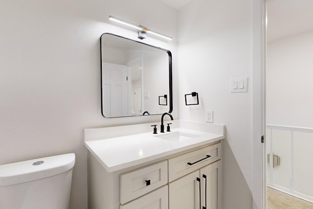 bathroom with toilet and vanity