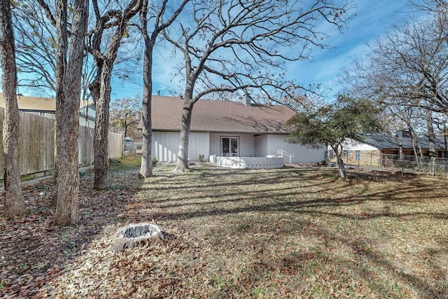 rear view of property featuring a yard