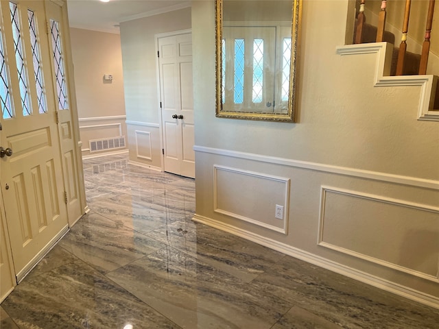 entrance foyer featuring crown molding