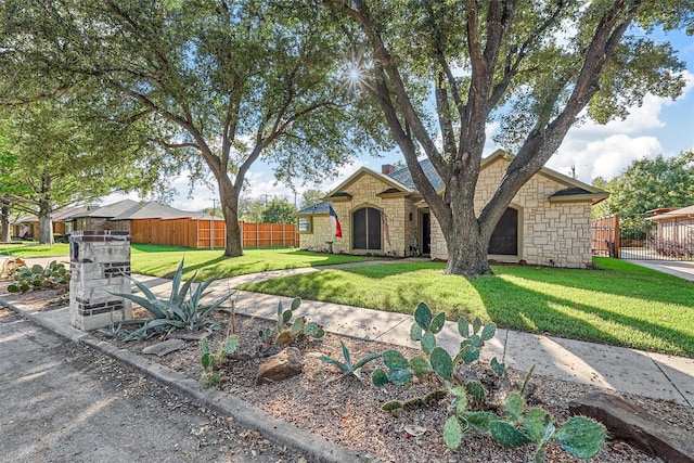 ranch-style house featuring a front lawn