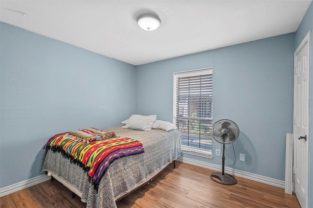 bedroom with hardwood / wood-style floors