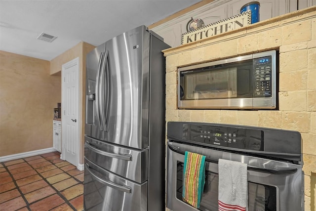 kitchen with stainless steel appliances and tile patterned floors