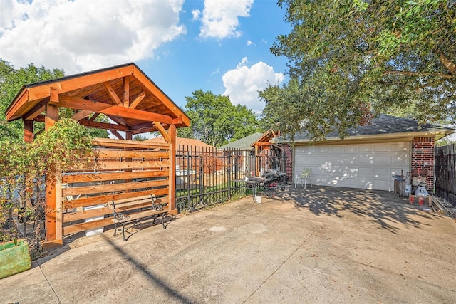 view of patio / terrace with a garage and an outdoor structure