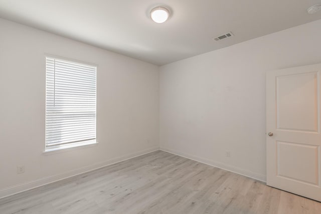 empty room featuring light wood-type flooring and a wealth of natural light