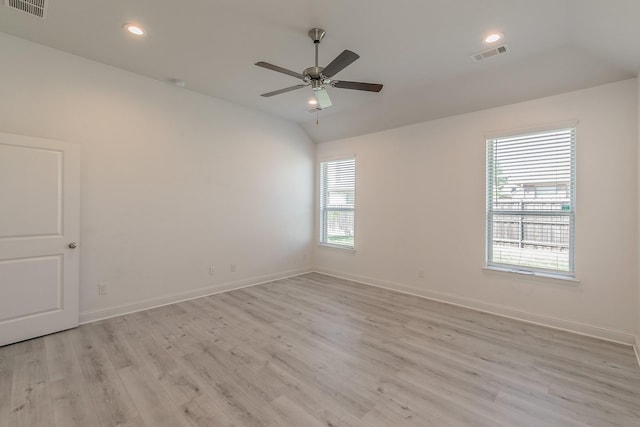 empty room with ceiling fan, light hardwood / wood-style flooring, and lofted ceiling