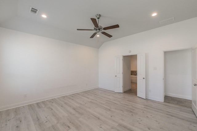 unfurnished bedroom with vaulted ceiling, ceiling fan, and light hardwood / wood-style flooring