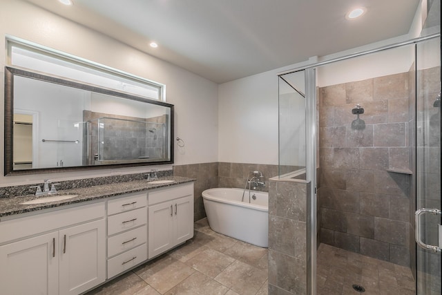 bathroom with vanity, tile walls, and independent shower and bath