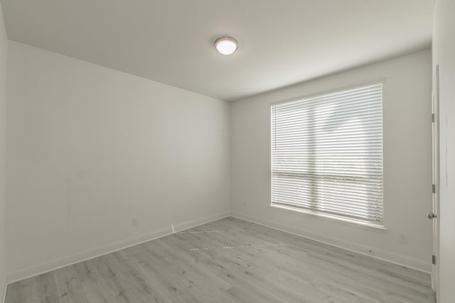 unfurnished room with light wood-type flooring