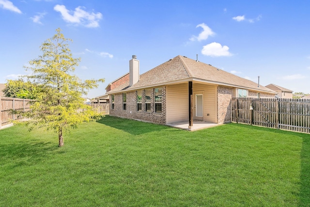 back of property featuring a lawn and a patio