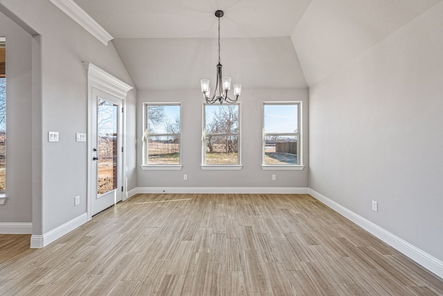 unfurnished dining area with a healthy amount of sunlight, light wood-style floors, and a notable chandelier