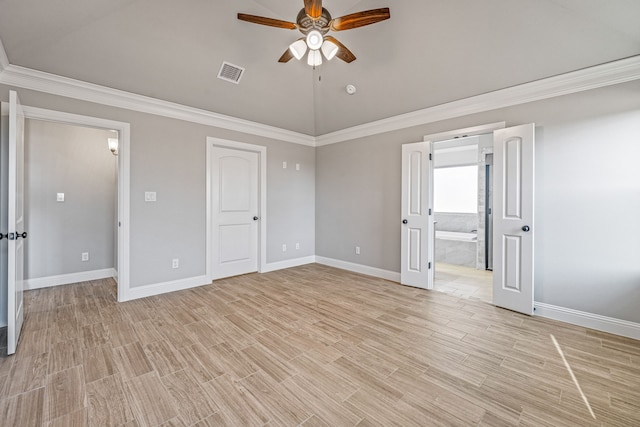 unfurnished bedroom featuring light wood-style floors, visible vents, vaulted ceiling, and crown molding