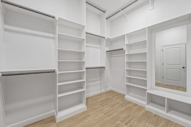 walk in closet featuring light wood-style floors