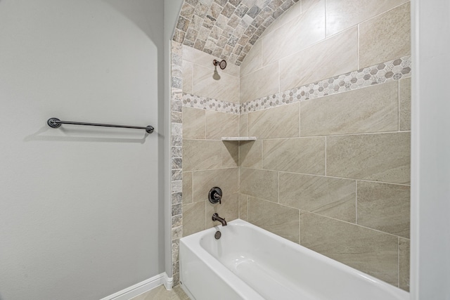 bathroom with shower / tub combination and baseboards