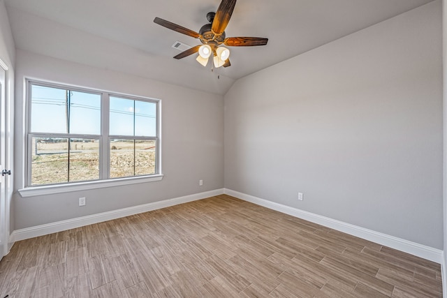 unfurnished room featuring baseboards, a ceiling fan, visible vents, and light wood-style floors