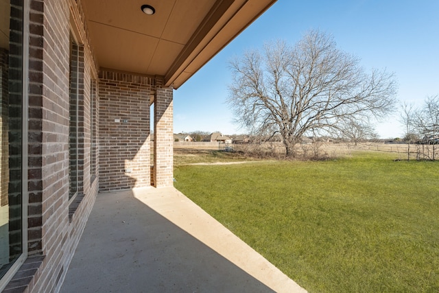 view of yard featuring a rural view and a patio area