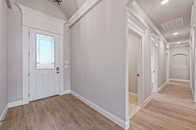 foyer entrance with light wood-style floors, recessed lighting, visible vents, and ornamental molding