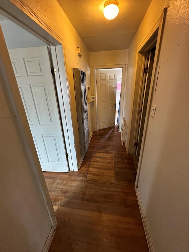 corridor featuring dark hardwood / wood-style flooring