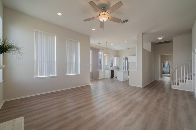 kitchen featuring a center island, white cabinets, and sink