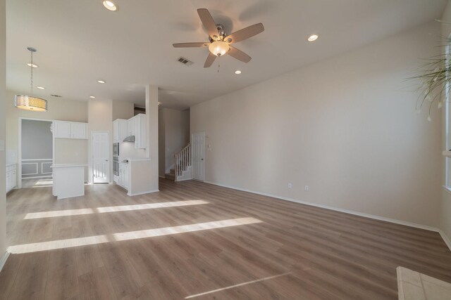 kitchen with stainless steel appliances, pendant lighting, white cabinets, and sink