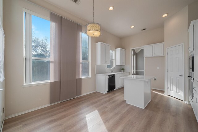 spare room featuring ceiling fan, light colored carpet, and vaulted ceiling