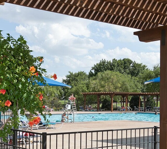 view of pool featuring a lawn