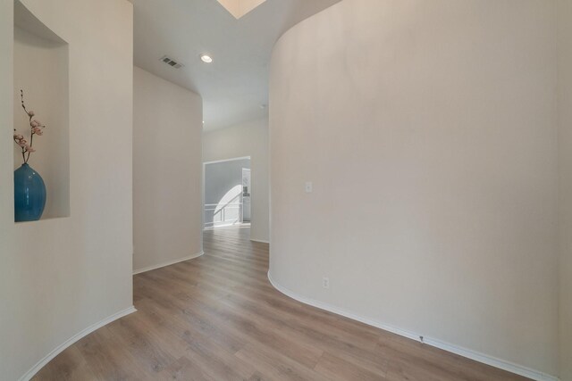 unfurnished living room with ceiling fan, light hardwood / wood-style floors, and a healthy amount of sunlight